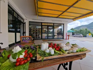 L'ingresso sotto la tenda gialla, con un tavolo di mozzarelle, ricotte e pomodorini