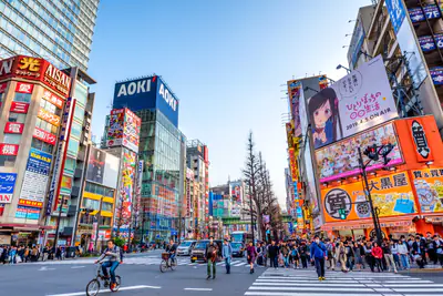 Un incrocio di Tokyo tra insegne luminose e grandi magazzini